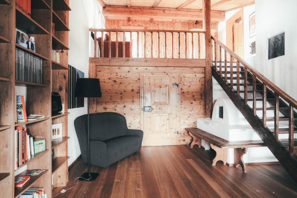 a room with a staircase and a chair and a table at Luna Mia - Apartment 5 in Schwangau