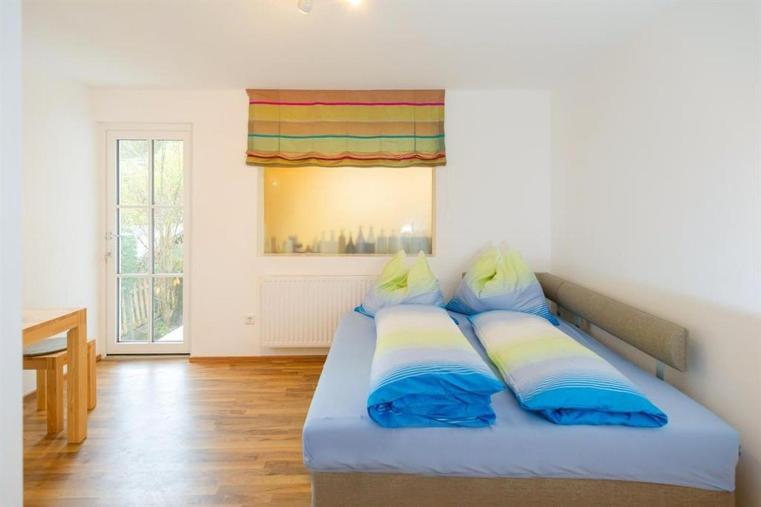 a bedroom with a bed with blue and yellow pillows at Appartement M&M in Schladming