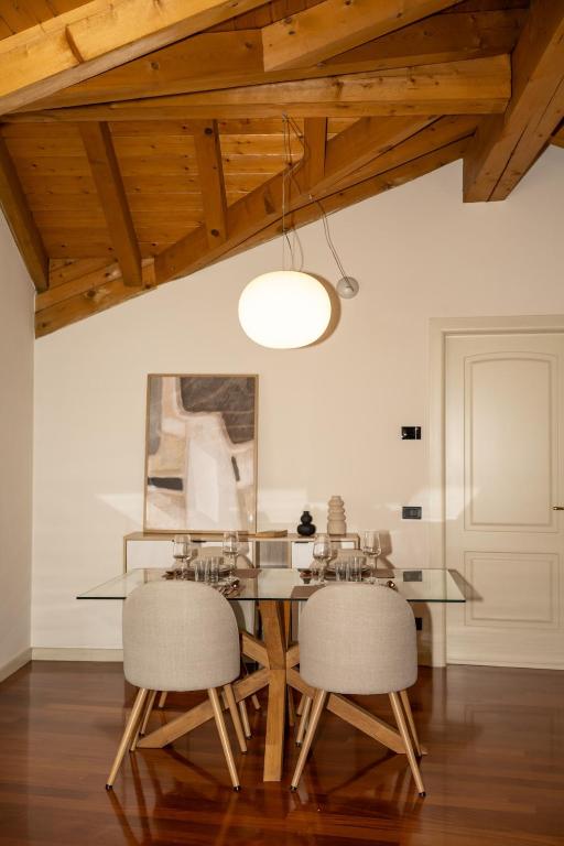 a dining room with a glass table and two chairs at Liberty Apartment in Lovere