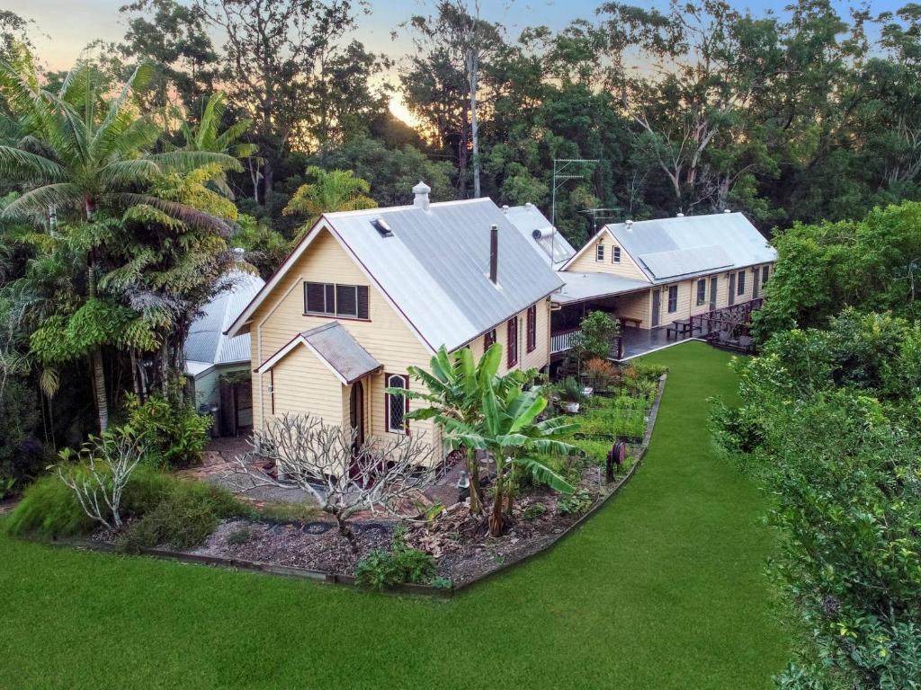an aerial view of a house with a yard at Glasshouse Mountains Ecolodge in Glass House Mountains