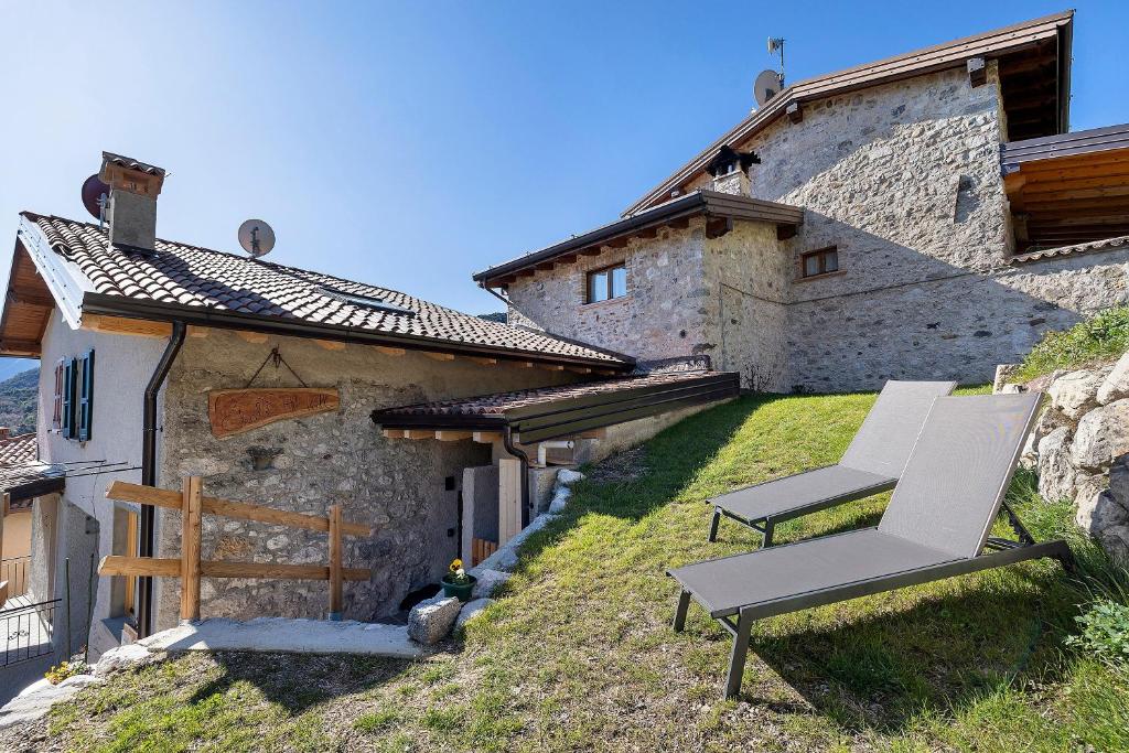 a pair of chairs sitting on the side of a building at Chalet Al Volt in Tremosine Sul Garda