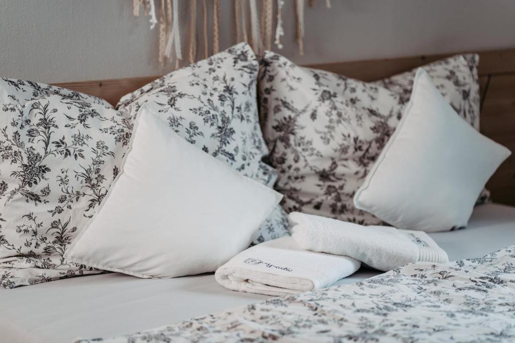 a bed with white pillows and towels on it at Einzigartig in Kuchl