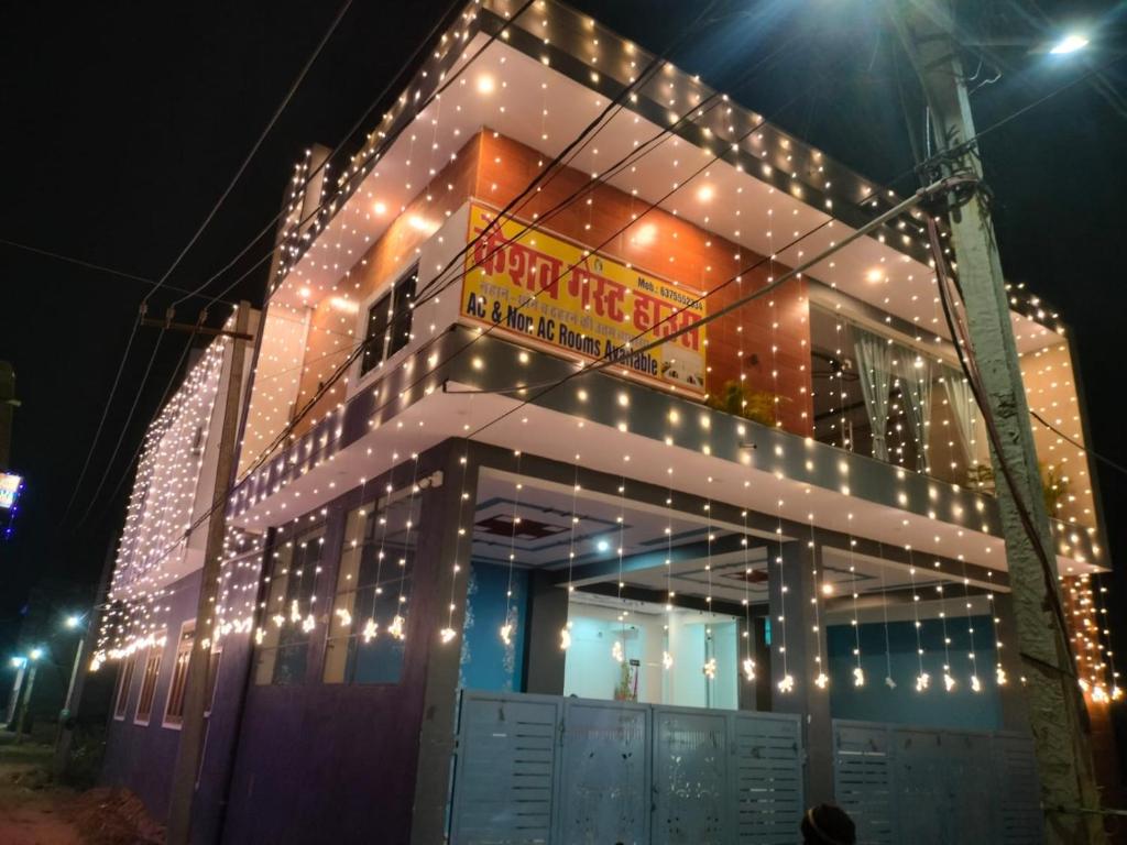 a building with christmas lights on the side of it at Keshav guest house in Rīngas