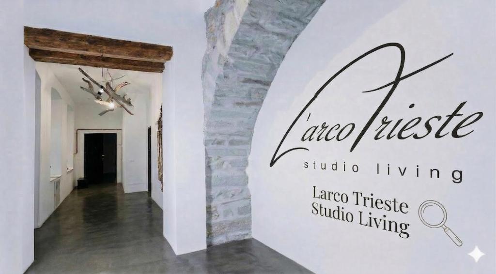 a hallway with a wall sign that reads into music studio living at L'Arco Trieste studio living 1 in Trieste