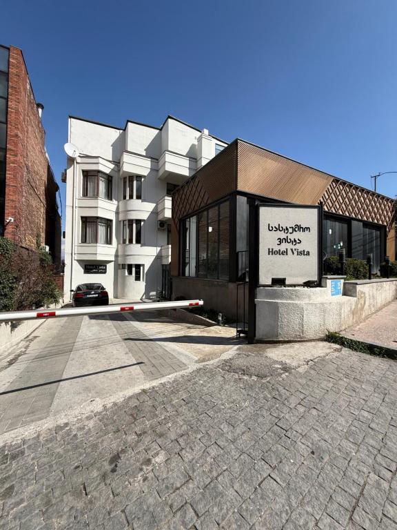 a building with a sign on the side of it at Hotel Vista in Tbilisi City