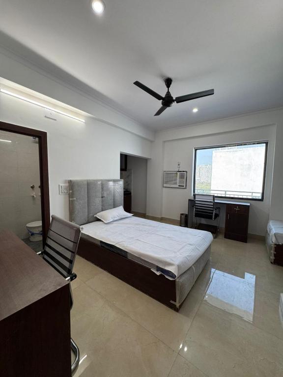 a bedroom with a bed and a ceiling fan at Sukoon Stays in Noida