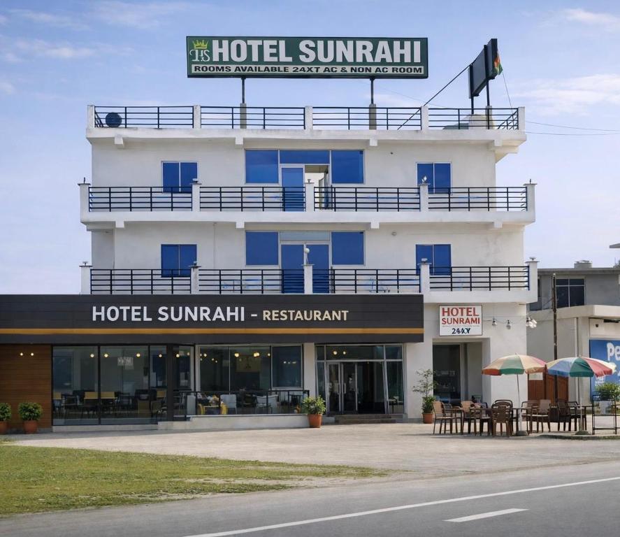 a hotel with a sign on top of it at Hotel Sunrahi in Nagīna