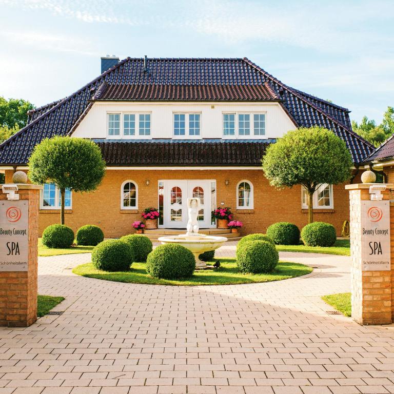 a house with a fountain in front of it at Beauty Concept SPA in Lübeck