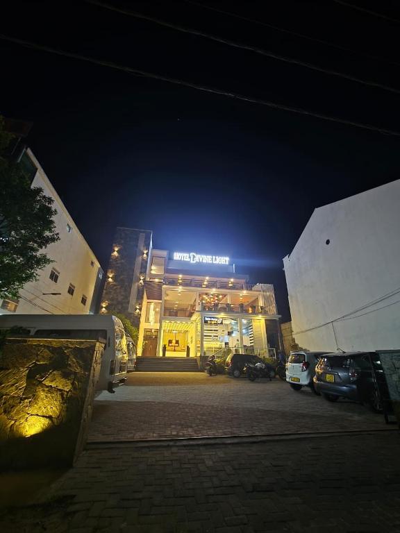 a building with a sign on it at night at Hotel Divine Light Monaragala in Monaragala