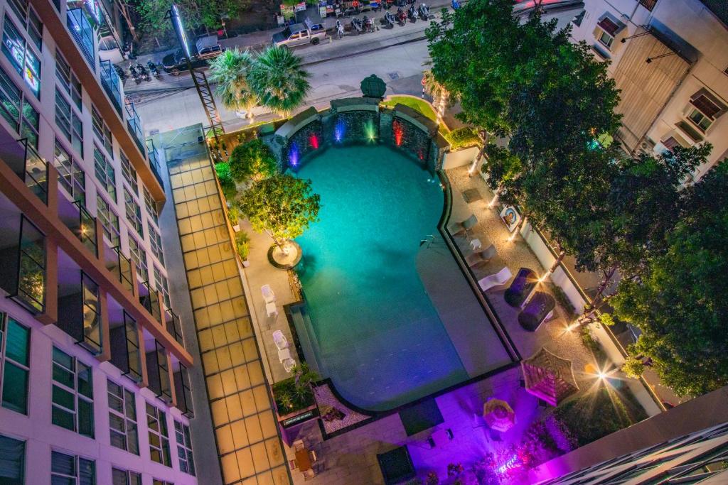 an overhead view of a swimming pool in a city at Dwija Hotel & Suite in Pattaya South