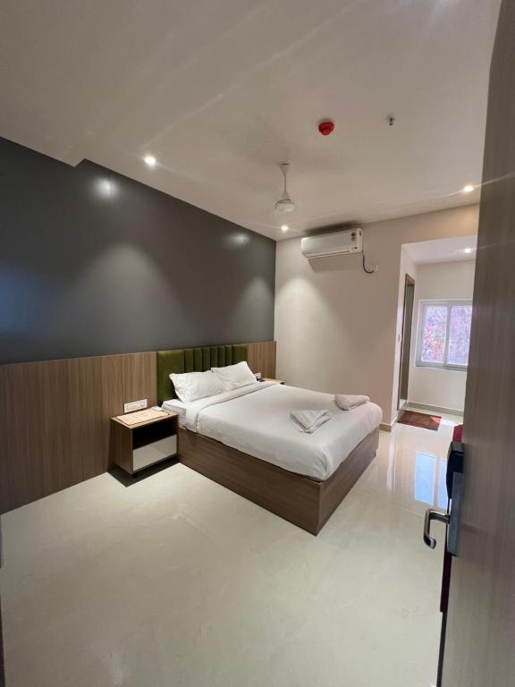 a bedroom with a large bed and a window at ishika grand in Secunderabad
