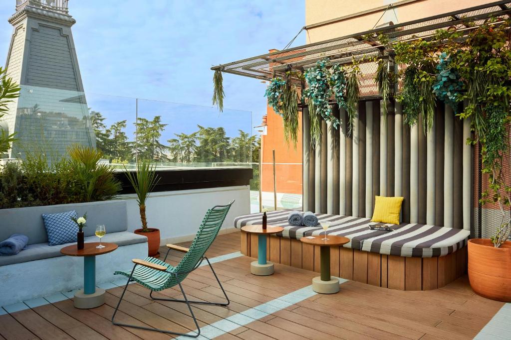 a patio with a table and chairs on a balcony at The Social Hub Madrid in Madrid