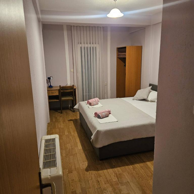 a small bedroom with a bed and a desk at Pansion San Pietro in Međugorje
