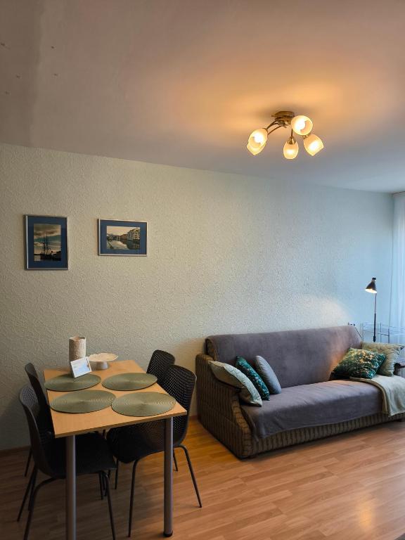 a living room with a couch and a table at Central Point Apartments in Rēzekne