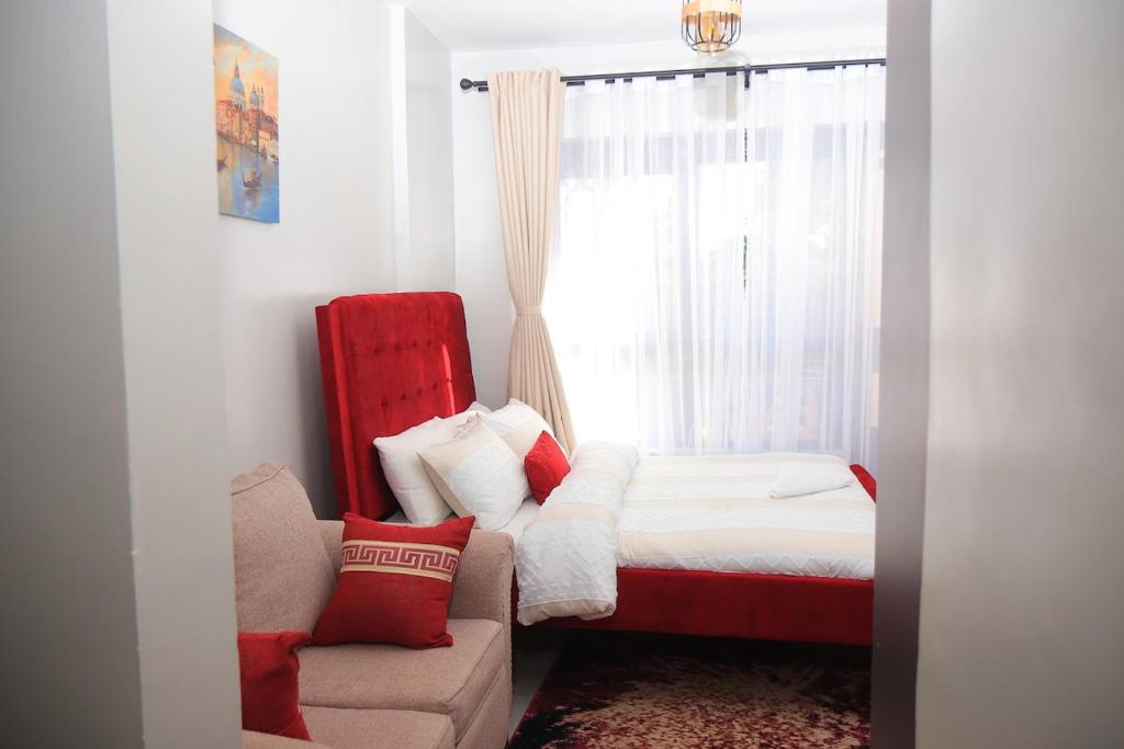 a bedroom with a bed and a couch and a window at Azure View Studio with pool in Kiahuria