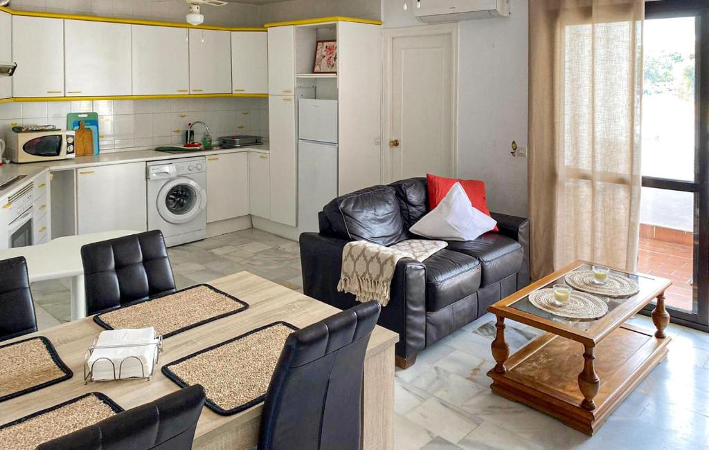 a living room with a leather couch and a table at 2 Bedroom Lovely Apartment In Estepona in Estepona