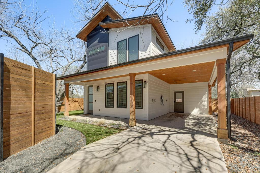 a home with a wooden fence in front of it at Chic Austin House w/ Spacious Backyard & Hammock in Austin