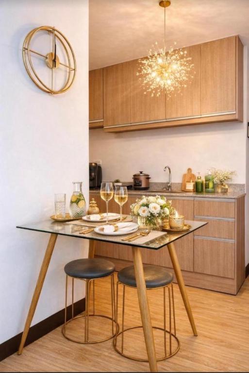 a kitchen with a table with glasses of wine at Super Cozy Condo Davao in Davao City