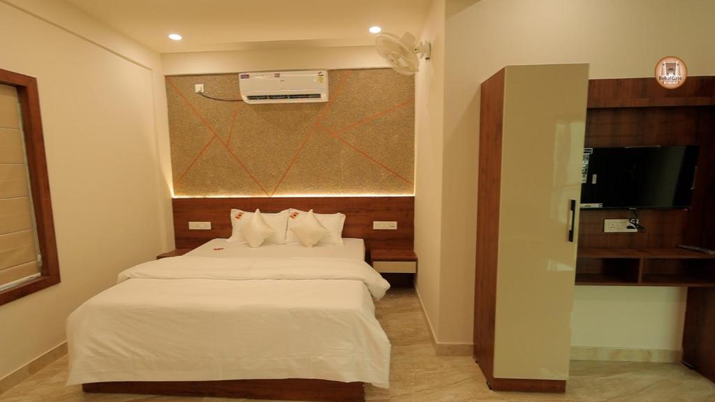a hotel room with a bed and a television at Bekal Gate Residency in Kotikulam