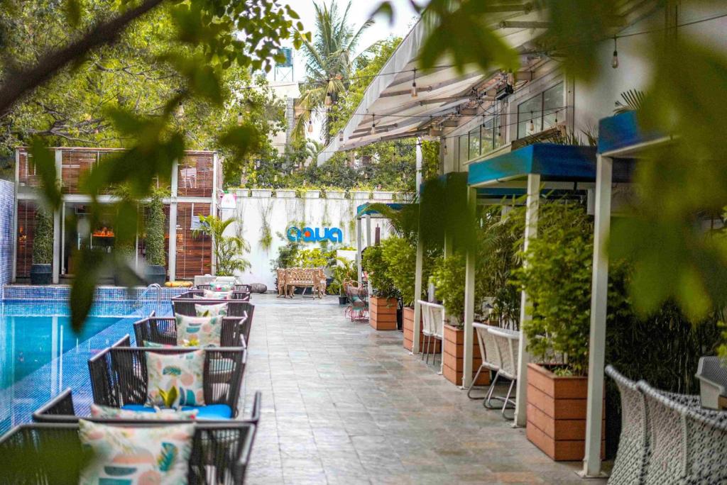 a patio with tables and chairs next to a pool at The Park Bangalore, MG Road in Bangalore