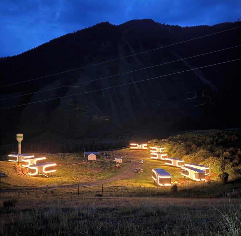 a group of buildings on a hill at night at Kolsay tany in Kurmenty