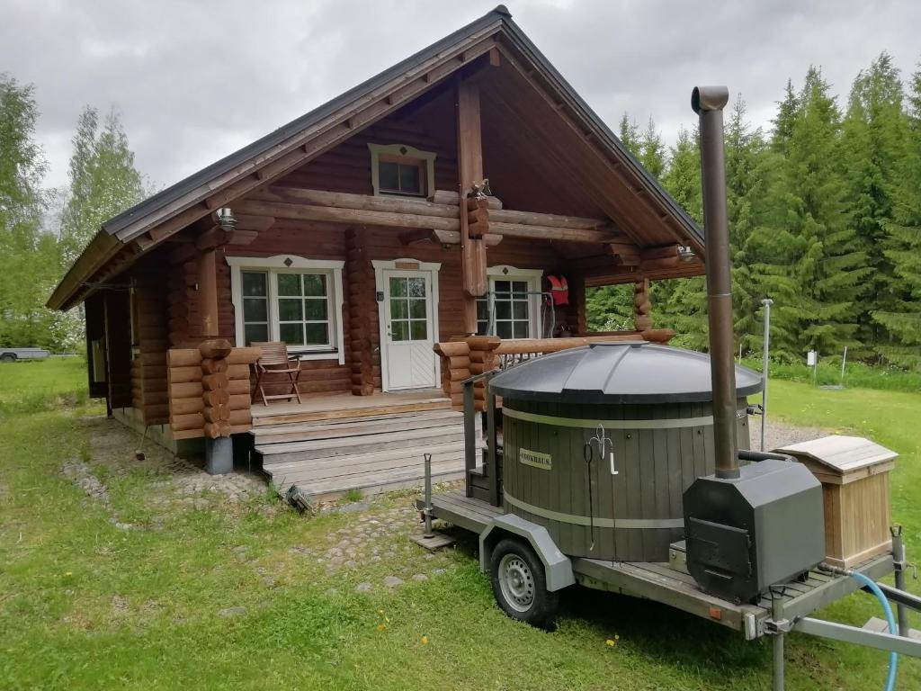 a log cabin with a gazebo in front of it at Cottage-karaoke Koivikko in Äänekoski