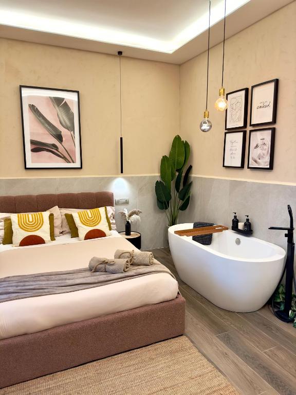 a bedroom with a bed and a bath tub in it at Falco Deluxe Home - Naples Airport & Town in Naples