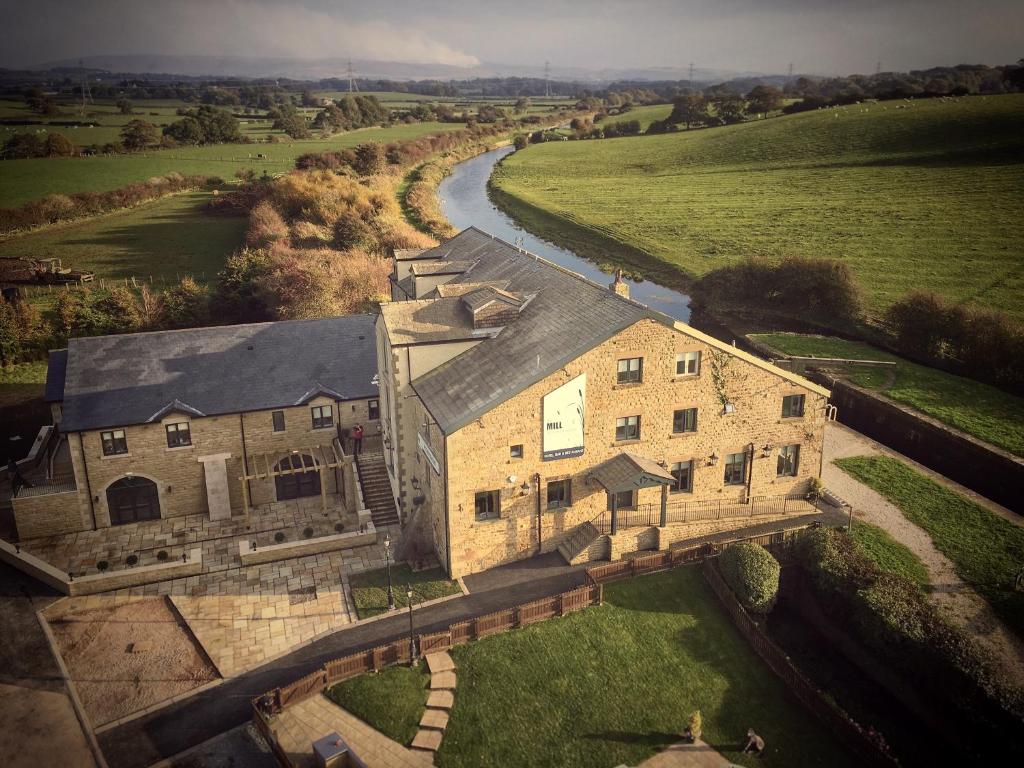 an aerial view of a large stone building with a river at The Mill at Conder Green in Conder Green