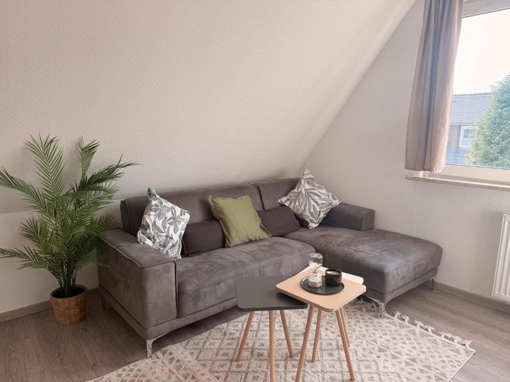 a living room with a couch and a table at Yunis Landhaus in Grömitz