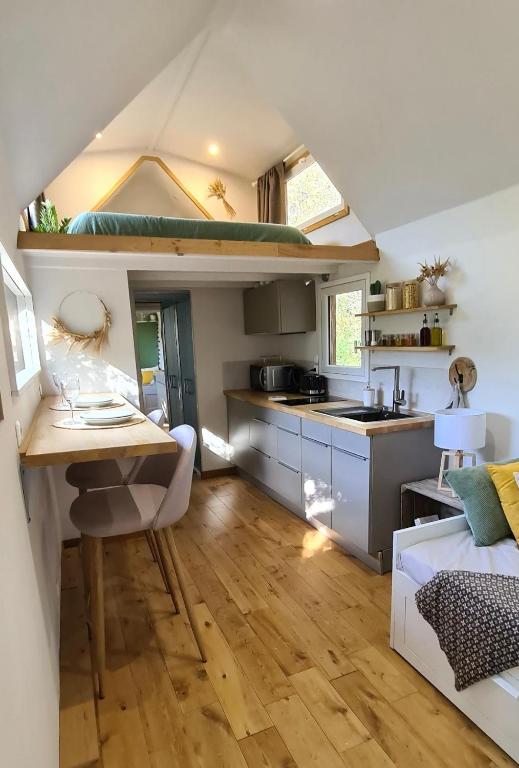a kitchen and living room with a desk in a tiny house at Tiny House Bord de Mer in Plouarzel