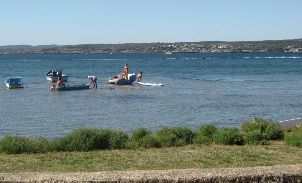 a group of people in a large body of water at Havre de paix au bord de létang de Thau avec vue-magnifiques couchers de soleil-et accès direct et privé à l'eau-possibilité de se garer gratuitement dans la rue in Sète