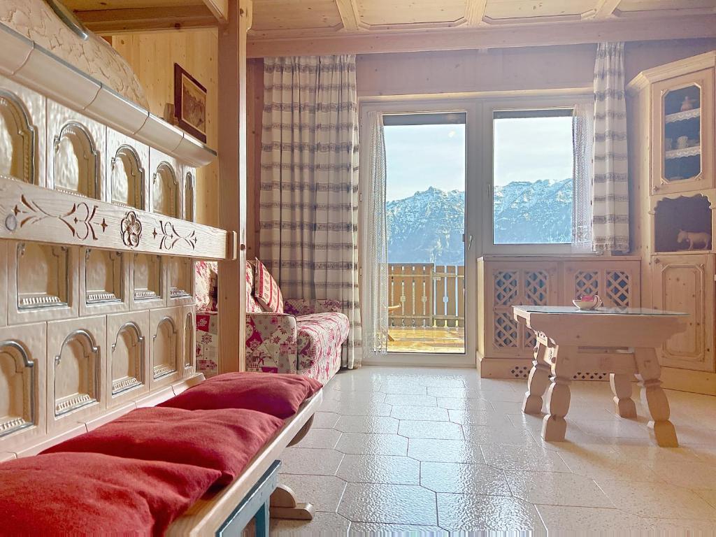 a living room with a couch and a table at Lagorai Wood Apartment in Telve