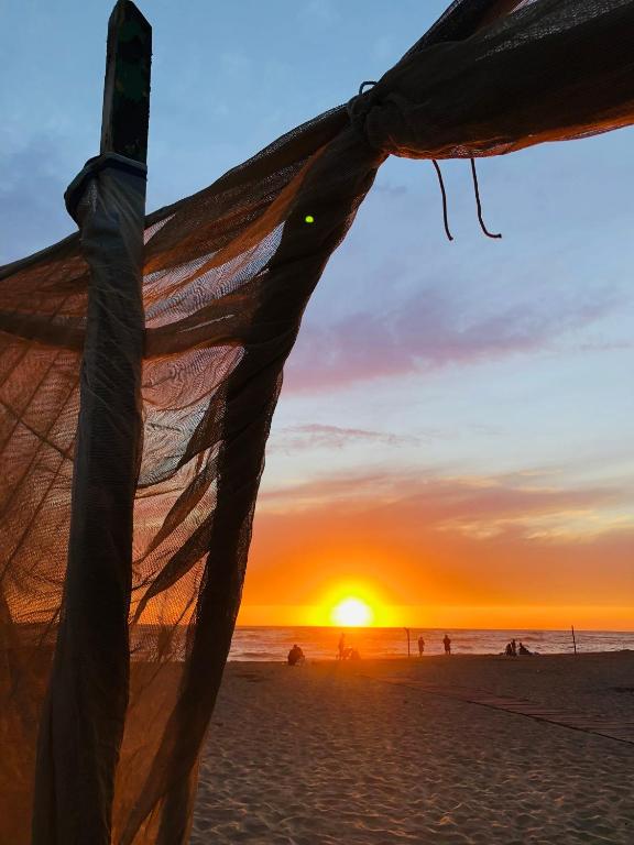 a view of the sunset from the beach at ALT alloggio turistico in Focene