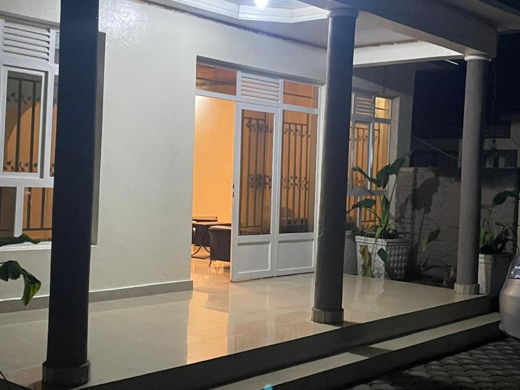 a room with columns and a door in a house at Kivu Breeze Apartment in Gisenyi