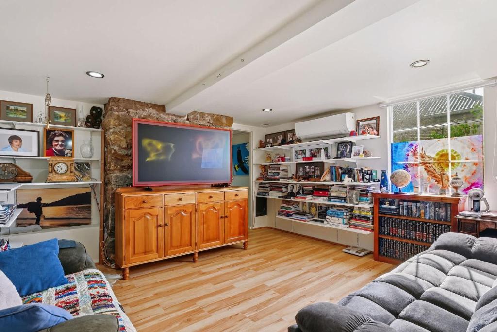 a living room with a flat screen tv at Birdcage - King Bed - Walk to CBD in West Hobart