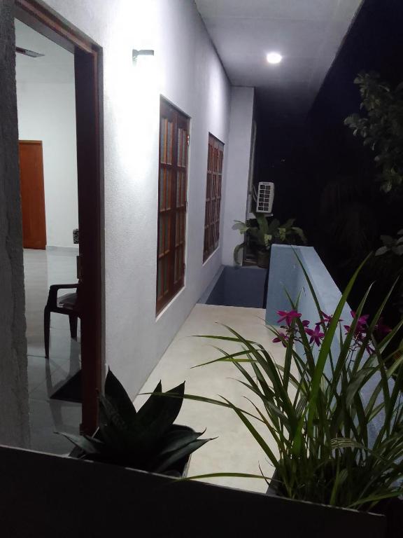 a room with a bed and some plants in it at Ocean whisper residence in Ahangama