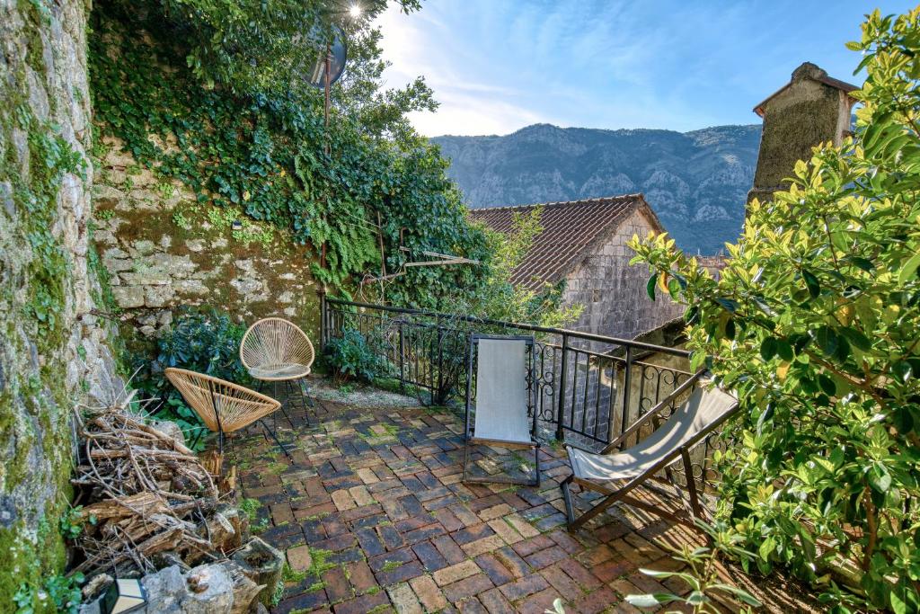 a balcony with two chairs and a railing at Best view! Rooftop with Garden - Old Town Nr404 in Kotor