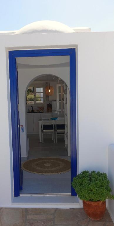 an open door into a kitchen with a table at Villa B - Kamari Village in Aliko Beach
