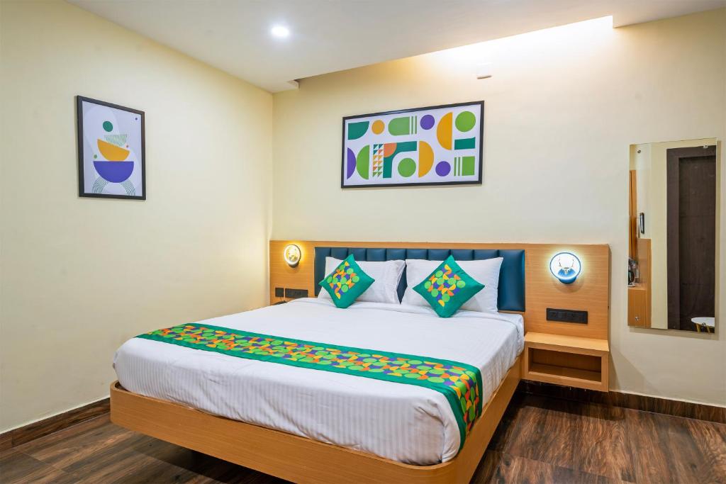 a bedroom with a large bed in a room at Treebo Grace Stays in Bhubaneshwar