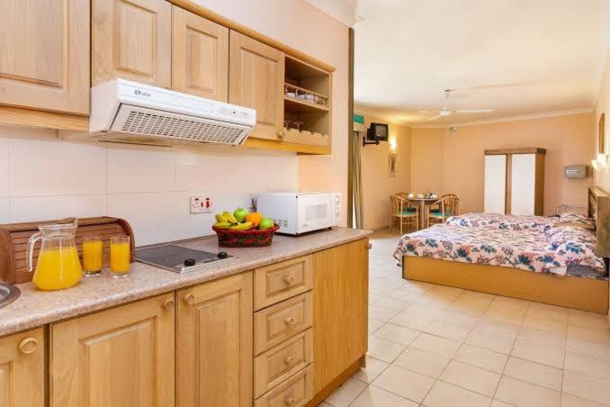 a kitchen with a counter top with a bed in a room at Quadruple Room 3629 in St. Paul's Bay