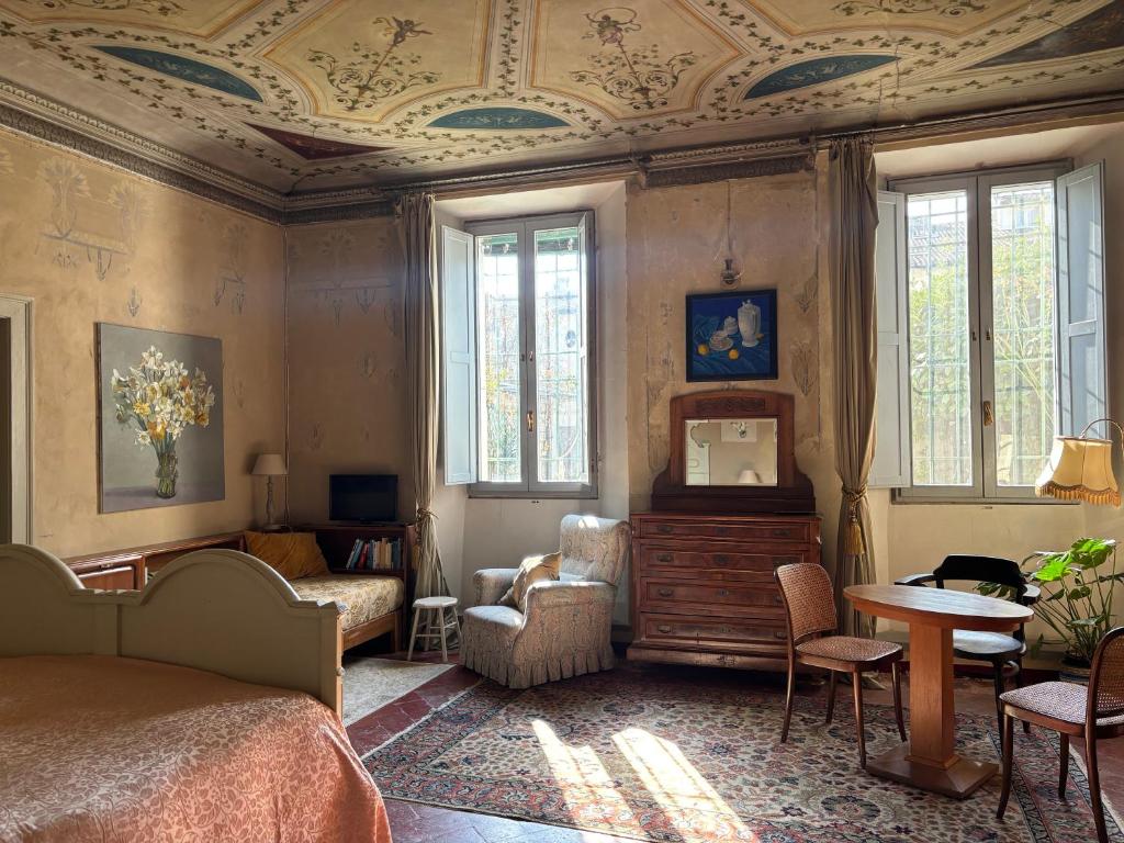 a bedroom with a bed and a table and chairs at adagio b&b in Faenza