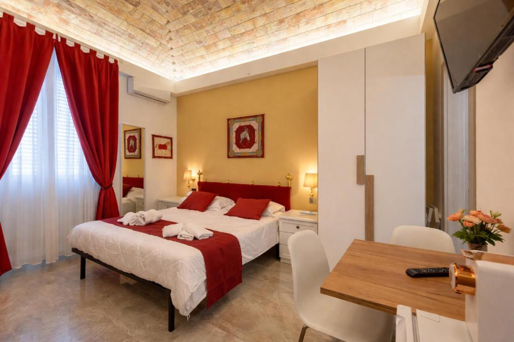 a bedroom with a bed and a table and a dining room at Urban Beach Sirena in Francavilla al Mare