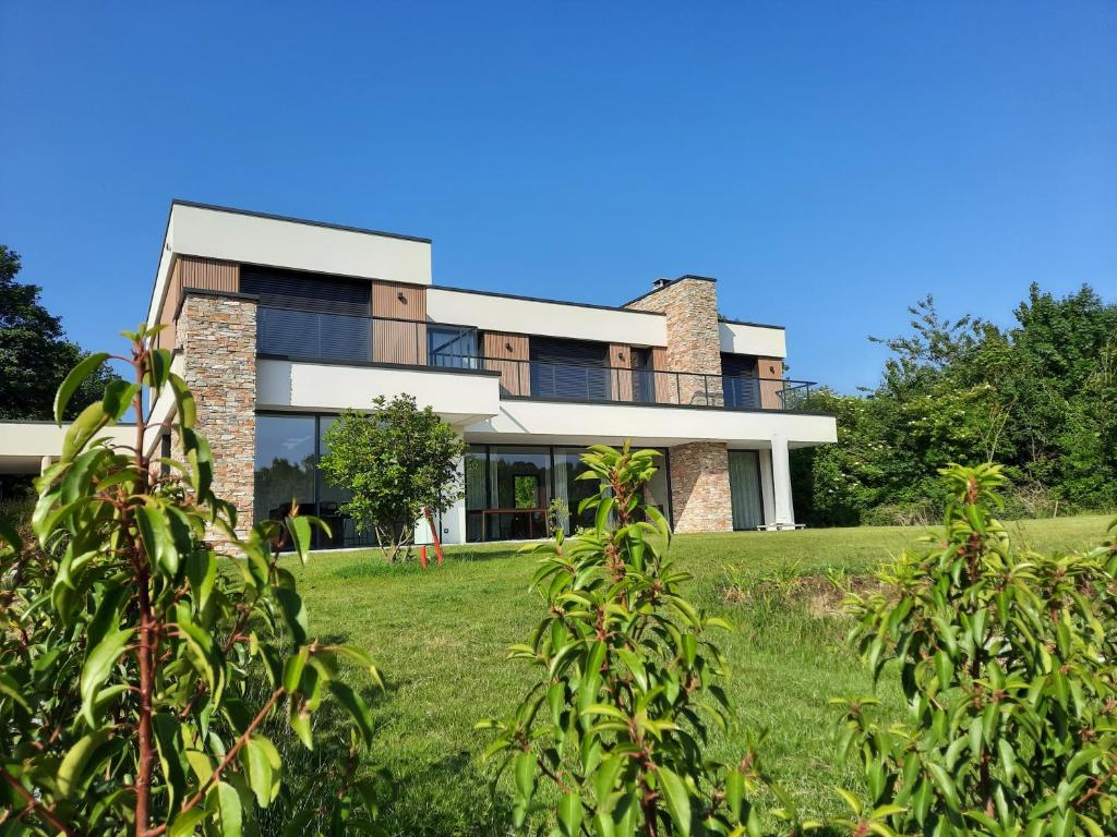 a house on a hill with green grass at Au Bon Cap in Hervelinghen