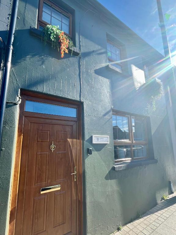 a building with a wooden door and a window at 31 Lower English in Armagh