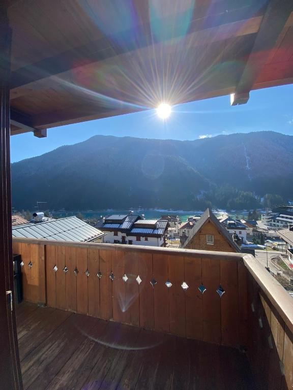 a balcony with a view of a city and mountains at Rosadira Vista Lago sulle Dolomiti in Auronzo di Cadore