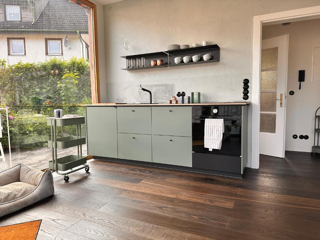 a kitchen with a sink and a stove at HAUS AM SEE - Natur Pur in Friedenweiler
