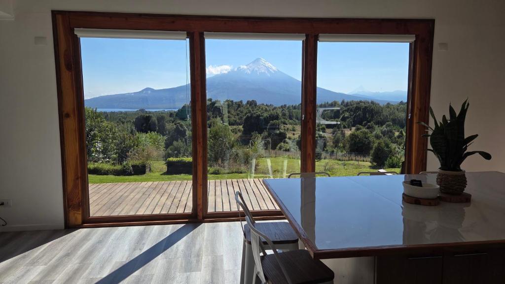 a kitchen with a view of a mountain through a window at Casa Vulkaan in Puerto Varas