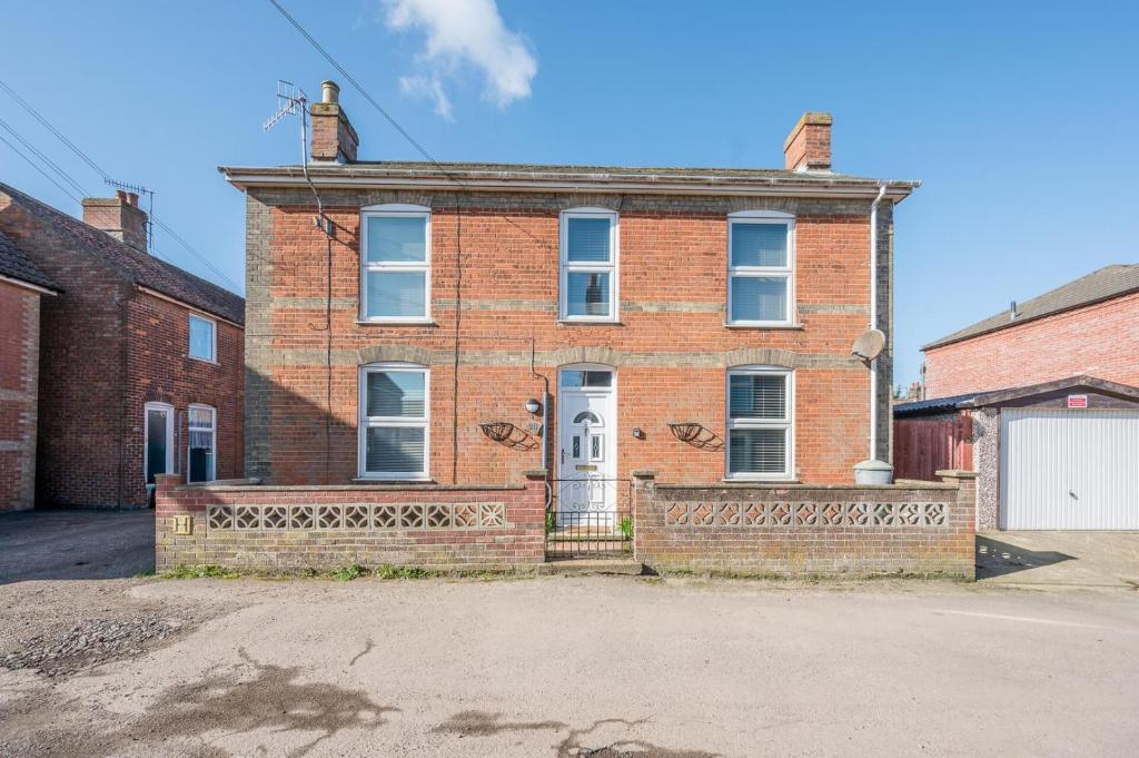 an old brick house with a white door at 38 Prospect Place, Leiston in Leiston