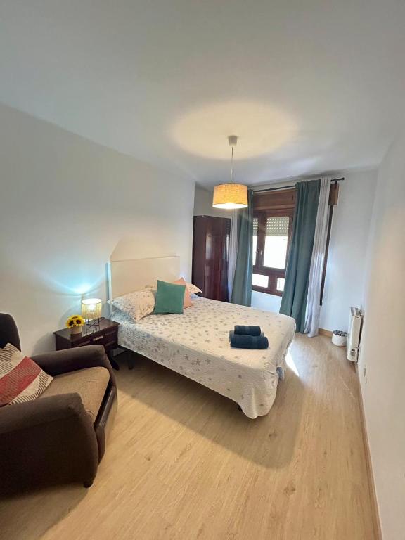 a living room with a bed and a couch at Del Valle 1 in Cudillero