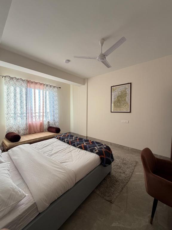 a bedroom with a large bed and a window at Aga Stay Apartment in Gangtok